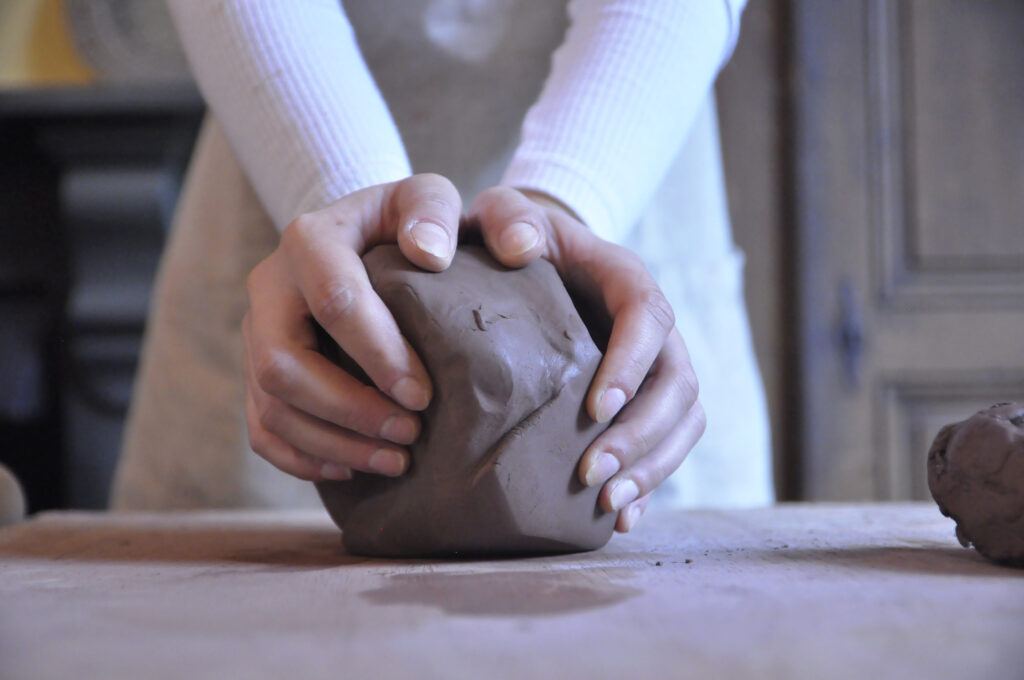 Hands wedging terracotta clay Handcrafted Ceramic Raw Terracotta